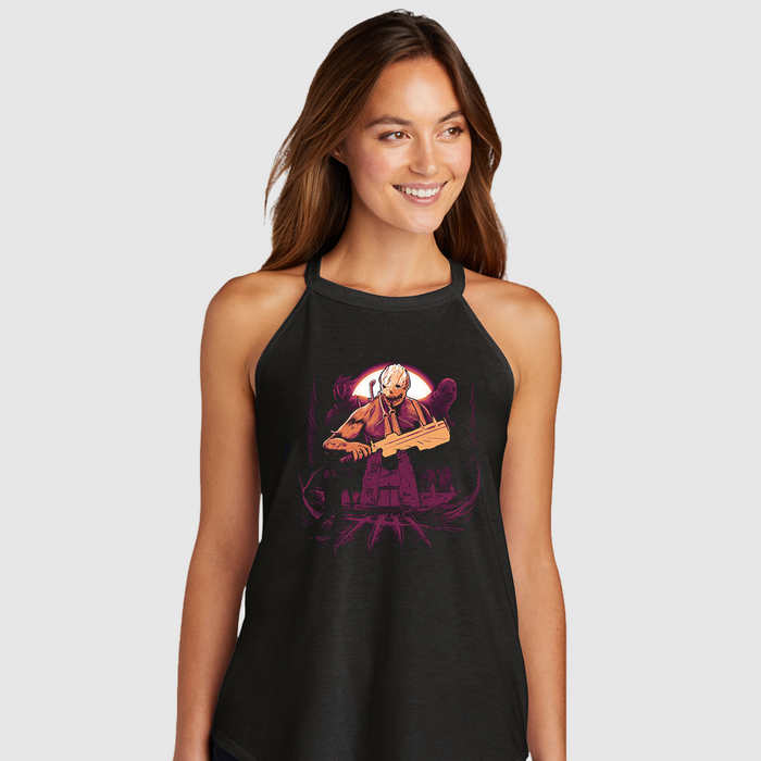 Woman wearing a black tank top with a graphic design on a plain background